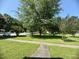 Well-manicured front yard with lush green grass and mature trees providing ample shade at 1500 Brent Ct # 9B, Burlington, NC 27215