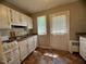 Practical kitchen layout features a countertop, sink, cabinets, and door to backyard at 1500 Brent Ct # 9B, Burlington, NC 27215