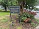 Brookwood Garden Condominiums sign surrounded by pink flowers, creating a welcoming entrance at 1500 Brent Ct # 9B, Burlington, NC 27215