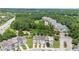 Drone's eye view showcases townhome community near green spaces, trees, and other residential areas at 1527 Haywards Heath Ln, Apex, NC 27502