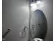 Cozy bathroom with an oval mirror and wall fixtures at 1527 Haywards Heath Ln, Apex, NC 27502