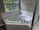 A corner soaking tub and a leafy view at 1527 Haywards Heath Ln, Apex, NC 27502