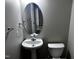 Cozy bathroom with an oval mirror, white sink and toilet at 1527 Haywards Heath Ln, Apex, NC 27502