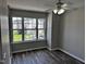 Bright bedroom with fan and large windows that provide lots of natural light and neighborhood views at 1527 Haywards Heath Ln, Apex, NC 27502