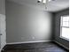 Bedroom features hardwood floors, white trim, and a ceiling fan at 1527 Haywards Heath Ln, Apex, NC 27502
