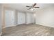 Spacious bedroom features multiple closets, wood-look flooring, and a ceiling fan at 1527 Haywards Heath Ln, Apex, NC 27502