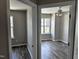 Inviting bedroom boasts modern wood flooring, fan, and double windows for natural light and comfort at 1527 Haywards Heath Ln, Apex, NC 27502