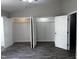 Spacious bedroom featuring modern floors, a ceiling fan and open double door closets at 1527 Haywards Heath Ln, Apex, NC 27502