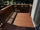 Exterior deck with wooden railings and sliding glass door access to interior at 1527 Haywards Heath Ln, Apex, NC 27502