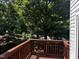 Wooden deck with brown railings overlooking a beautiful, green, leafy yard at 1527 Haywards Heath Ln, Apex, NC 27502