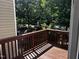A wood deck overlooks a beautiful yard with mature trees providing privacy at 1527 Haywards Heath Ln, Apex, NC 27502