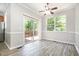 Cozy dining area features wood-look floors, sliding glass doors to the deck, and a ceiling fan at 1527 Haywards Heath Ln, Apex, NC 27502