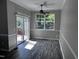 A dining room has a fan, sliding doors to deck, and large windows with view of greenery at 1527 Haywards Heath Ln, Apex, NC 27502