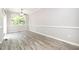 Dining room with wood-look floors, ceiling fan, and a large window for natural light at 1527 Haywards Heath Ln, Apex, NC 27502