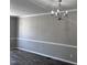 Dining room featuring chair rail and an elegant chandelier at 1527 Haywards Heath Ln, Apex, NC 27502