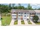 An aerial view shows townhomes boasting well-kept lawns, shrubbery, stone accents, and attached garages at 1527 Haywards Heath Ln, Apex, NC 27502