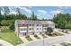 Drone's eye view showcases modern townhomes with manicured lawns, private entrances, and attached garages at 1527 Haywards Heath Ln, Apex, NC 27502