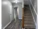 Bright foyer with new gray paint, wood laminate floors, and carpeted stairs leading to the second level at 1527 Haywards Heath Ln, Apex, NC 27502