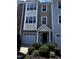 Charming townhome with attached garage, well-kept landscaping, and inviting front entrance at 1527 Haywards Heath Ln, Apex, NC 27502