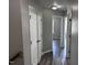 Hallway with modern floors, neutral paint and white doors at 1527 Haywards Heath Ln, Apex, NC 27502