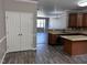The kitchen overlooks the living room and has an island, stainless appliances, and wood floors at 1527 Haywards Heath Ln, Apex, NC 27502