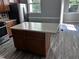 A kitchen island features light countertops and wood cabinets, with stainless steel appliances at 1527 Haywards Heath Ln, Apex, NC 27502