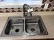 Double stainless steel sink with tile backsplash in kitchen setting at 1527 Haywards Heath Ln, Apex, NC 27502