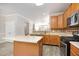 Bright kitchen features an island, stainless steel appliances, and a view into the living area at 1527 Haywards Heath Ln, Apex, NC 27502