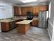 A kitchen features wooden cabinets, stainless steel appliances, and an island at 1527 Haywards Heath Ln, Apex, NC 27502