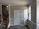 Living room with carpeted staircase and window at 1527 Haywards Heath Ln, Apex, NC 27502