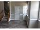 Living room with staircase and laminate flooring at 1527 Haywards Heath Ln, Apex, NC 27502