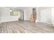 Bright living room features wood-look floors, neutral paint, and a staircase leading to the upper level at 1527 Haywards Heath Ln, Apex, NC 27502