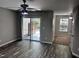 A living room with fan, hardwood floors, and sliding glass doors at 1527 Haywards Heath Ln, Apex, NC 27502