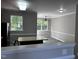 Bright, open-concept living room with large windows and modern ceiling fan at 1527 Haywards Heath Ln, Apex, NC 27502