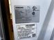 Close-up of a Samsung refrigerator label showing model and serial number at 1527 Haywards Heath Ln, Apex, NC 27502