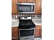 Stainless steel Whirlpool gas range stove with brown backsplash tiles at 1527 Haywards Heath Ln, Apex, NC 27502