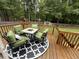 Relax on the back deck with a seating area overlooking the spacious, wooded backyard at 195 Windsong Ln, Youngsville, NC 27596