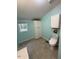 Cozy bathroom with a window, storage, and a modern toilet at 195 Windsong Ln, Youngsville, NC 27596