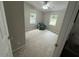 Small, cozy bedroom has a chair near windows at 195 Windsong Ln, Youngsville, NC 27596