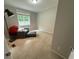 Bedroom features a large window, a pull-out chair, and a lamp at 195 Windsong Ln, Youngsville, NC 27596