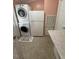 Bright laundry room features stacked washer and dryer next to a full-size refrigerator at 195 Windsong Ln, Youngsville, NC 27596