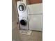 Laundry room features stacked washer/dryer and a full-size refrigerator at 195 Windsong Ln, Youngsville, NC 27596