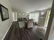 Cozy living room with hardwood floors, a large window, and comfortable seating at 195 Windsong Ln, Youngsville, NC 27596
