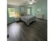 Relaxing bedroom with natural light, wood-look flooring, and comfortable furnishings at 195 Windsong Ln, Youngsville, NC 27596
