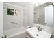 Well-lit bathroom with tub and shower combo has a grab bar and updated vanity and mirror at 202 Crest Rd, Cary, NC 27513