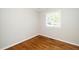 The bedroom features hardwood floors and a window providing ample natural light at 202 Crest Rd, Cary, NC 27513