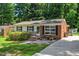 Beautifully landscaped home with a brick exterior and manicured front yard at 202 Crest Rd, Cary, NC 27513
