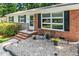 Inviting front entrance with brick accents, neutral paint, and a well-manicured garden at 202 Crest Rd, Cary, NC 27513
