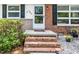 Close-up of a brick front porch with brick steps and decorative welcome mat at 202 Crest Rd, Cary, NC 27513