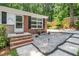 Charming front entrance with brick steps, pea gravel, and quaint seating area at 202 Crest Rd, Cary, NC 27513
